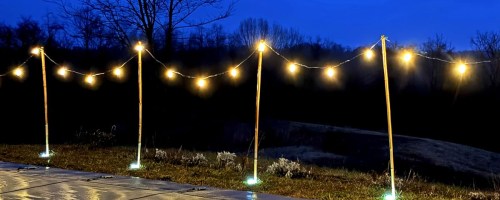 string lights on poles in backyard
