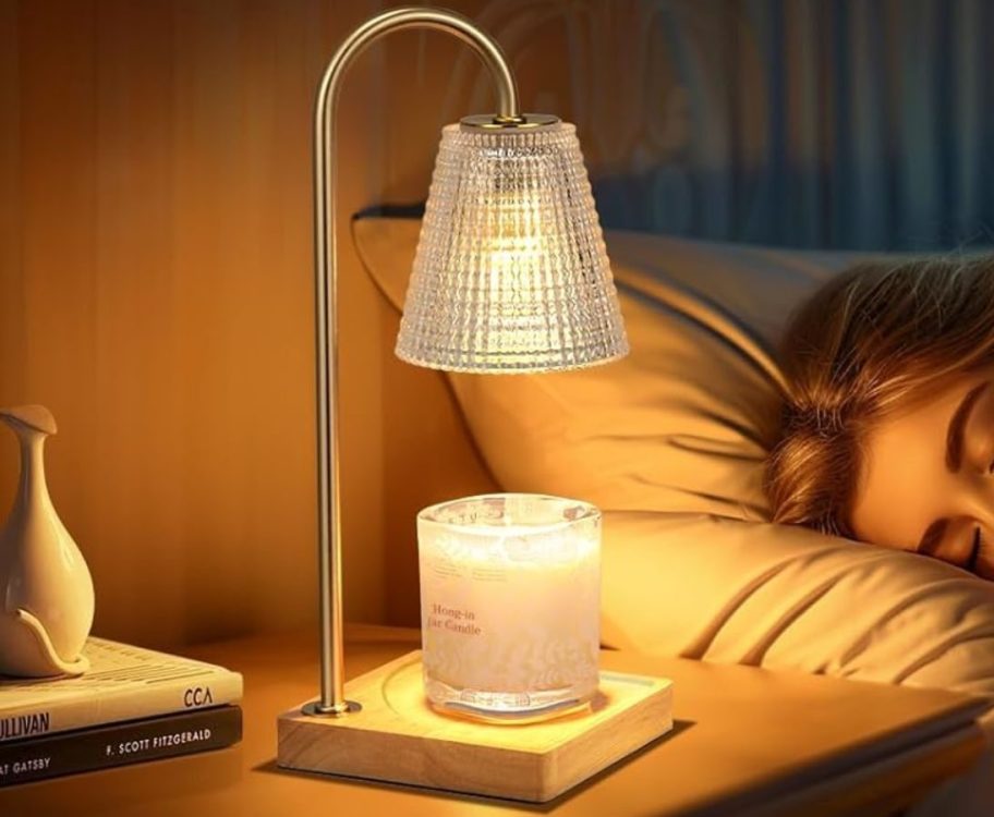 a candle lamp next to a bed