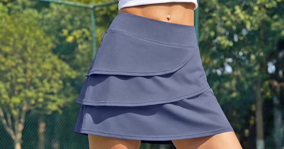 woman wearing a grey tennis skirt