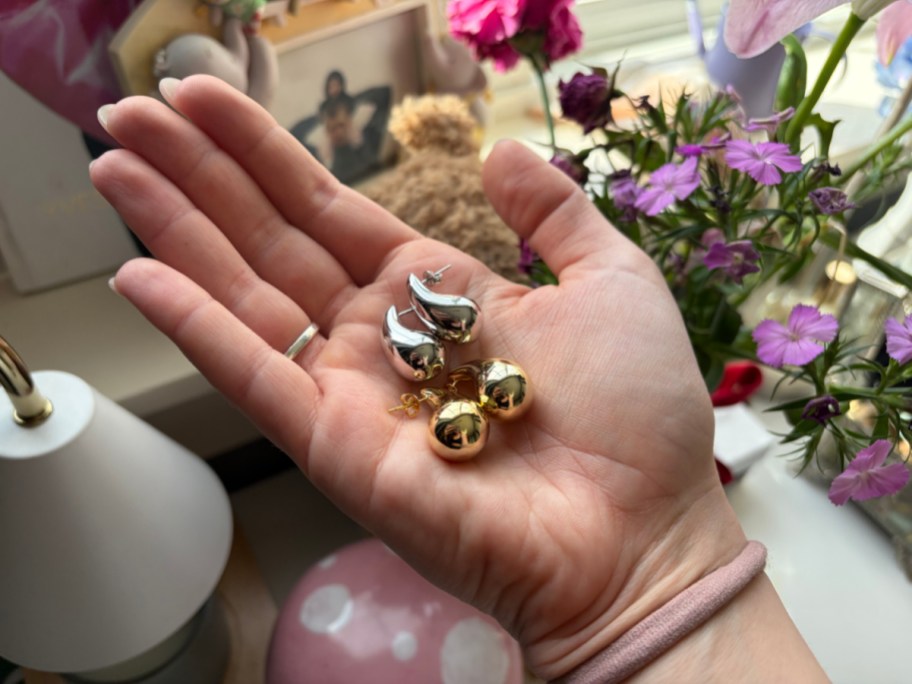 Cate & Chloe Olive Teardrop Stud Earrings in hand