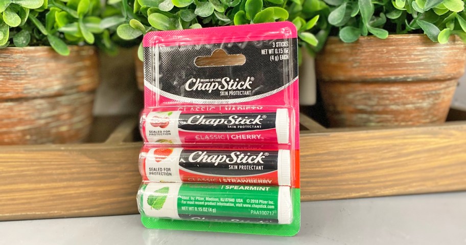 variety pack of chapsticks leaning against plant