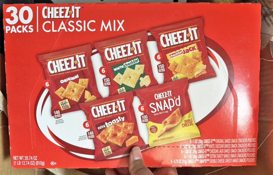 hand holding red variety pack box of Cheez-Its