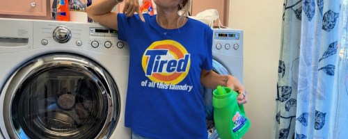 Woman wearing blue graphic T-shirt in laundry room