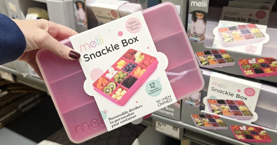 hand holding up a snackle box in store