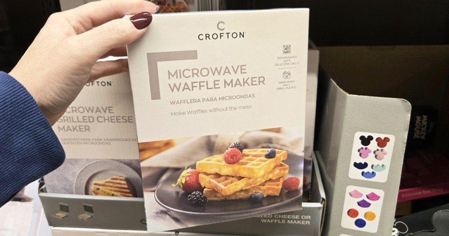hand holding a box to a Microwave Waffle Maker in store