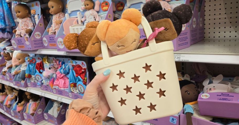 Hand holding Dolls in basket at the store
