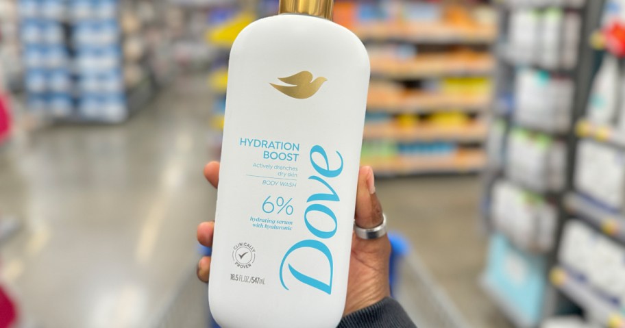 hand holding a white and blue bottle of Dove Body Wash in store