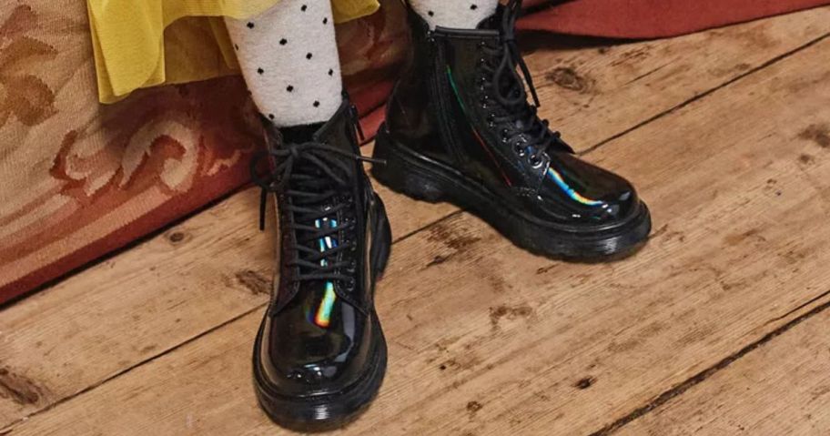 Girl wearing Dr Martens Rainbow Patent Boots