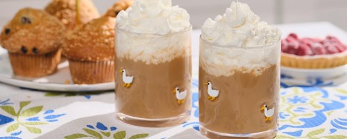 Glasses with little duck icons filled with hot chocolate and whipped cream