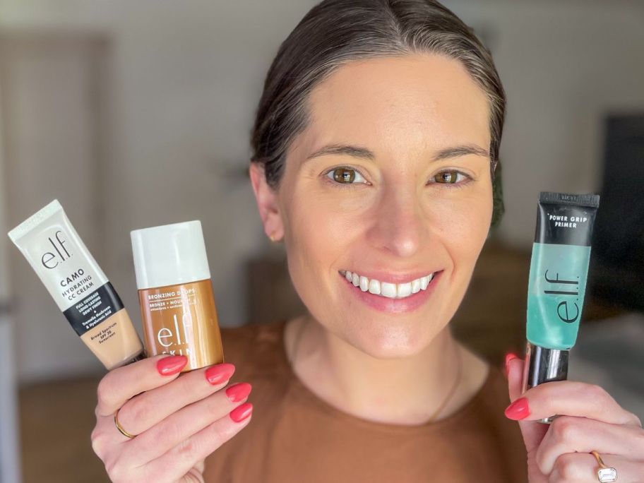 woman holding e.l.f. cosmetics