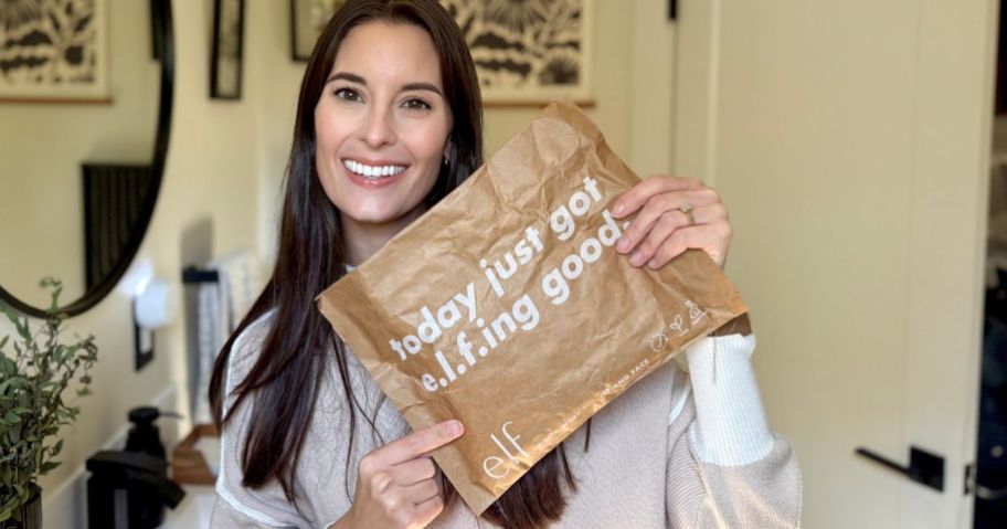 Woman holding a package from e.l.f. cosmetics