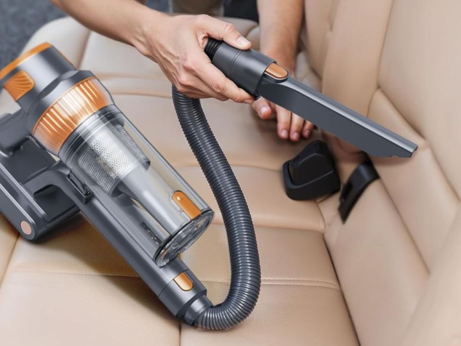 person using EzyTidy Cordless Vacuum Cleaner in car