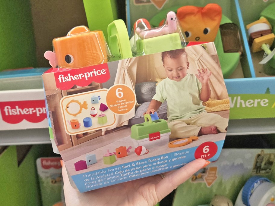 hand holding up Fisher-Price Friendship Forest Sort & Store Tackle Box toy in store