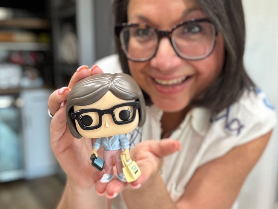 Woman holding a Funko Pop Figure