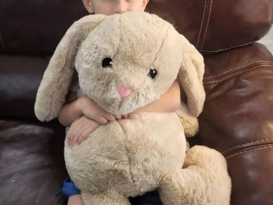 kid holding Gigglescape 18" Jumbo Tan Bunny Stuffed Animal