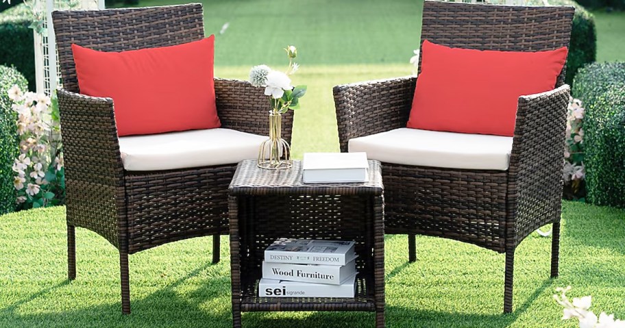 wicker patio chairs with matching side table in grass
