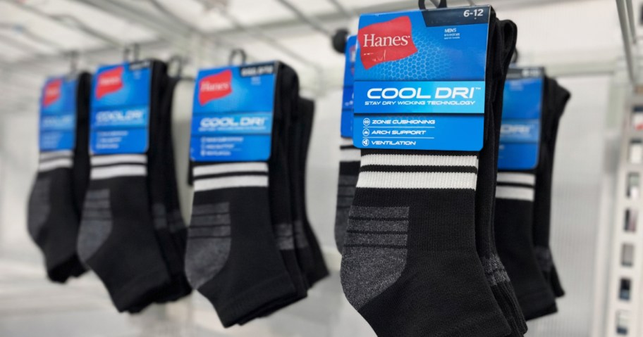black packages of socks hanging on store display wall