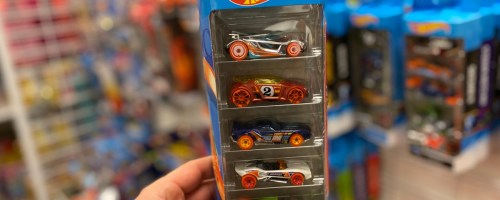 Hand holding up hot wheels, multi pack