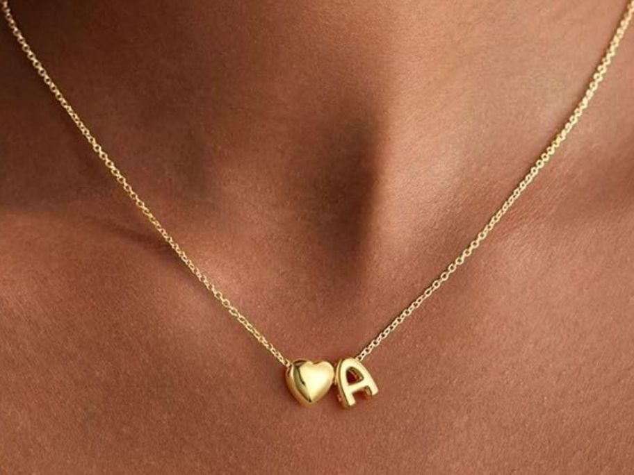 A gold heart initial necklace with the letter A