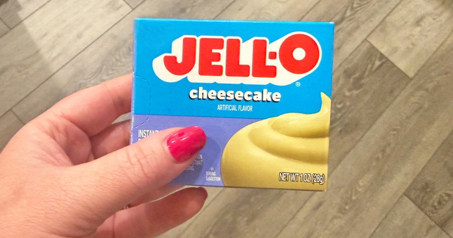 hand holding a box of jello pudding mix
