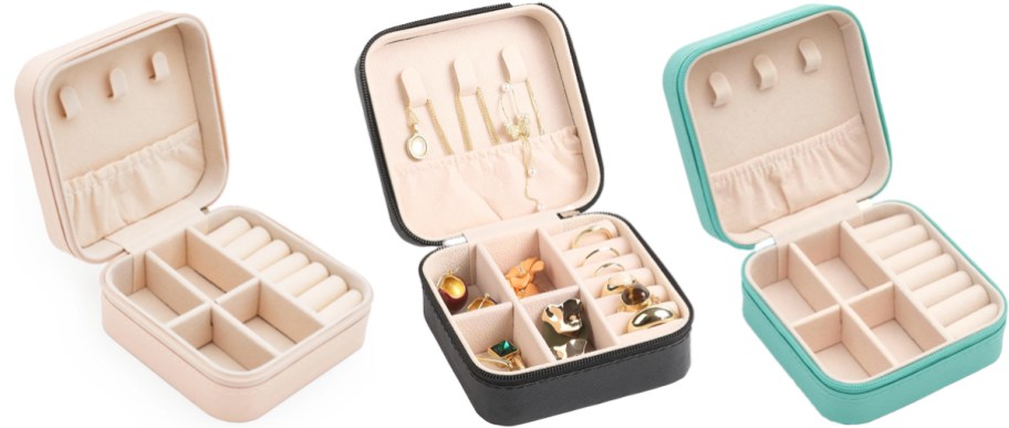 pink, black, and teal opened jewelry travel cases in a row
