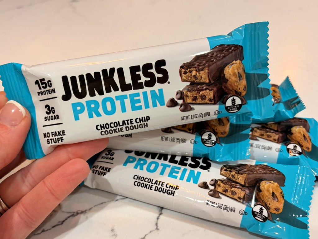 hand holding junkless protein bars in chocolate chip cookie flavor