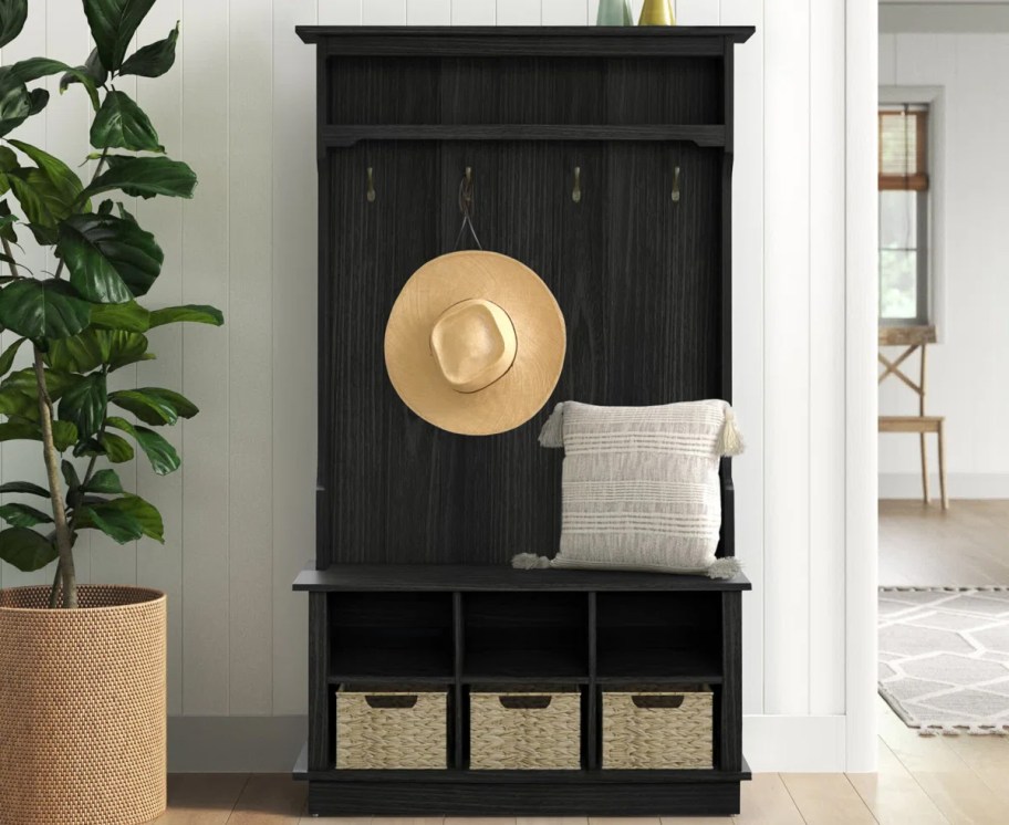 black hall tree with storage baskets at bottom