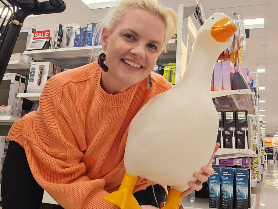 woman holding a porch goose from Kohl's