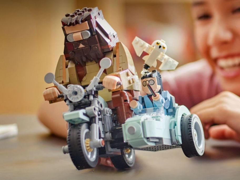 kid playing with LEGO Harry Potter Hagrid & Harry's Motorcycle Ride