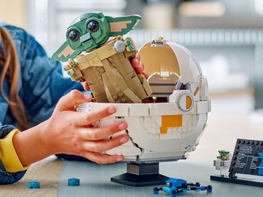 kid holding LEGO Star Wars Grogu w/ Hover Pram