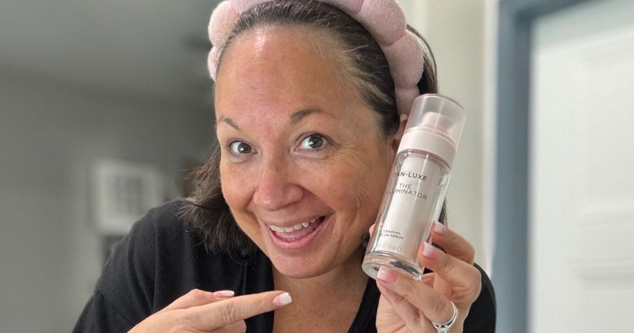 Woman holding Self tanner in her hands