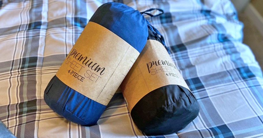 blue and black sheets sets on top of plaid comforter