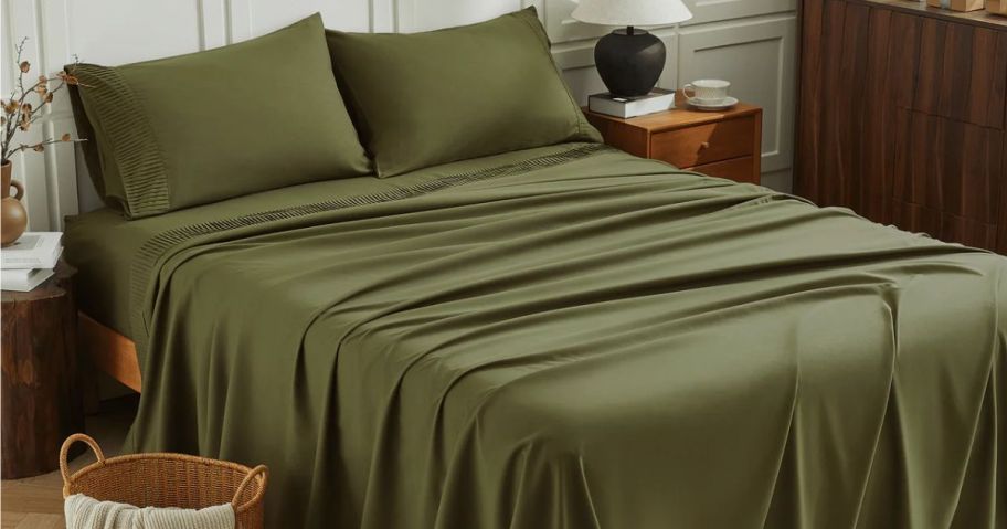 Bed with olive green Litanika Cooling sheets on it