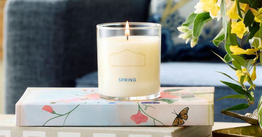 Lowe's Spring Candle on a stack of books