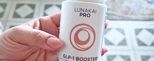 hand holding a white bottle of Lunakai PRO GLP-1 Booster