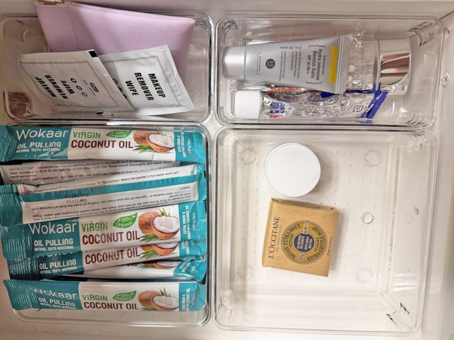 beauty products in clear organizers inside a drawer