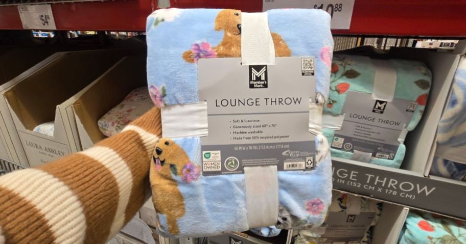 Springtime Dogs throw blanket in hand in store