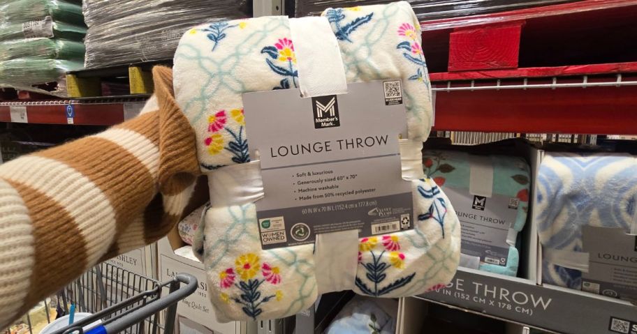 Block Print Floral Trellis throw blanket in hand in store