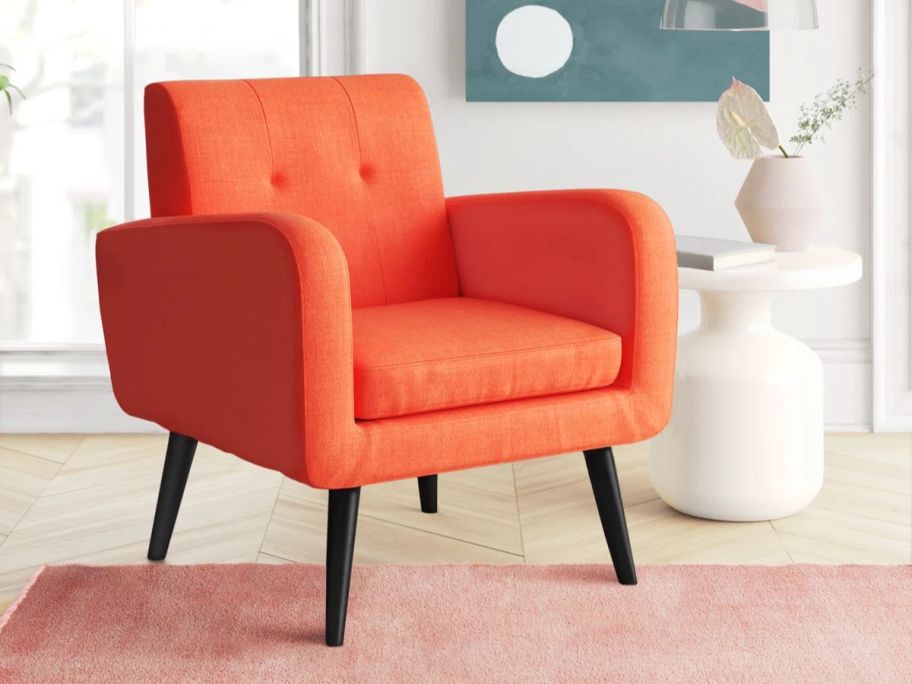 orange Mercury Row Almeda Tufted Polyester Armchair in living room