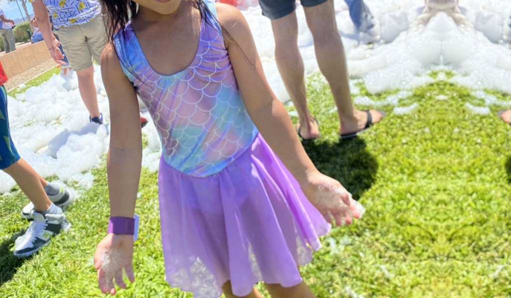 Girl wearing leotard with skirt in purple with pattern