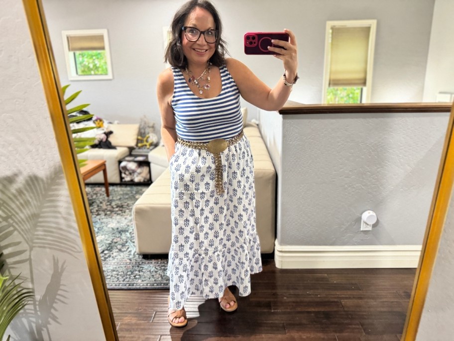 a woman in a midi dress taking a selfie