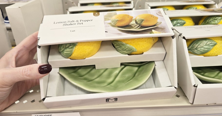 hand holding a set of lemon shaped salt & pepper shakers