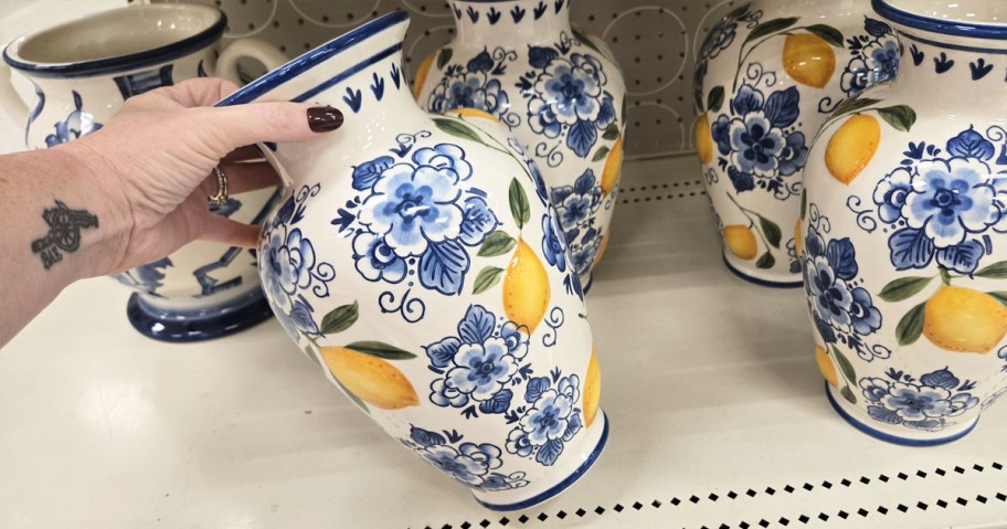 hand holding a floral and lemon print vase