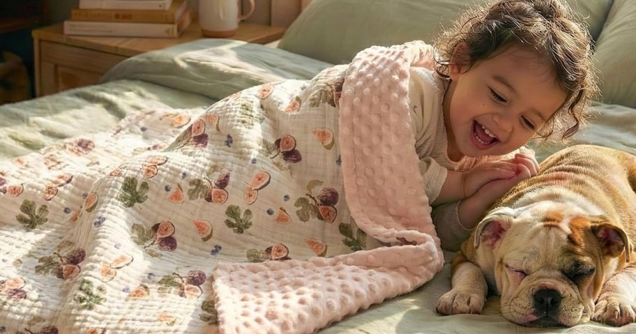 Muslin and Fleece Baby Blanket being used by toddler on a bed with her puppy