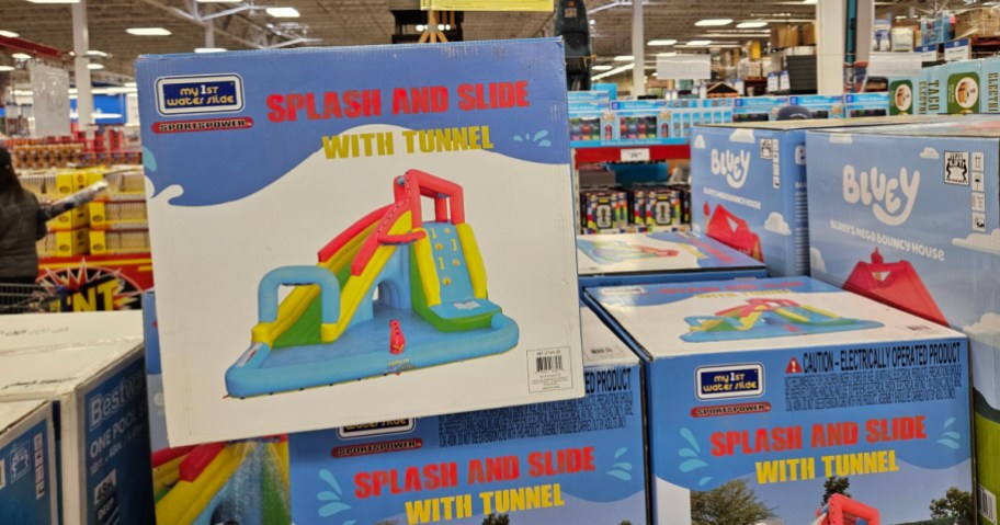 A boxed water slide toy with colorful features, labeled "Splash and Slide with Tunnel."
