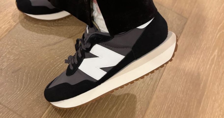 Man's foot wearing New Balance 237s
