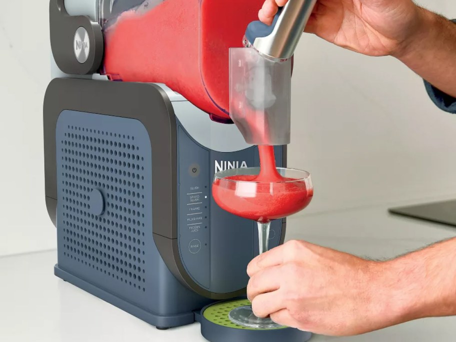 dispensing slushie drink into a glass