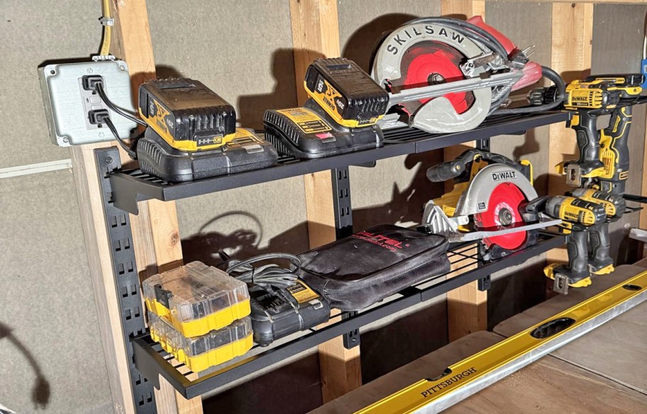 various power tools and chargers on shelves in garage