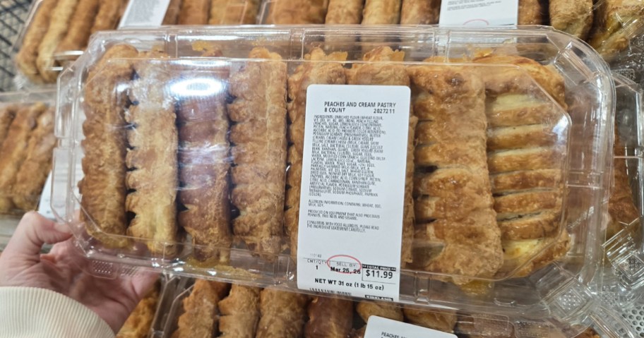 hand holding a container ot Peaches & Cream Pasteries in store