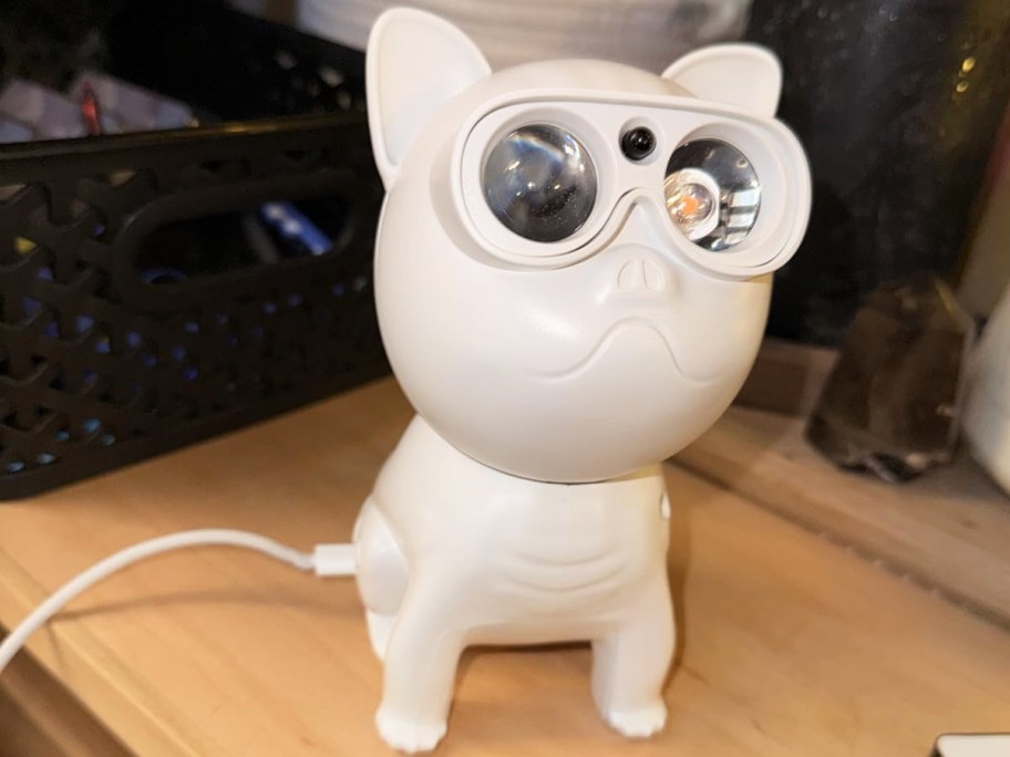 dog shaped galaxy projector on nightstand